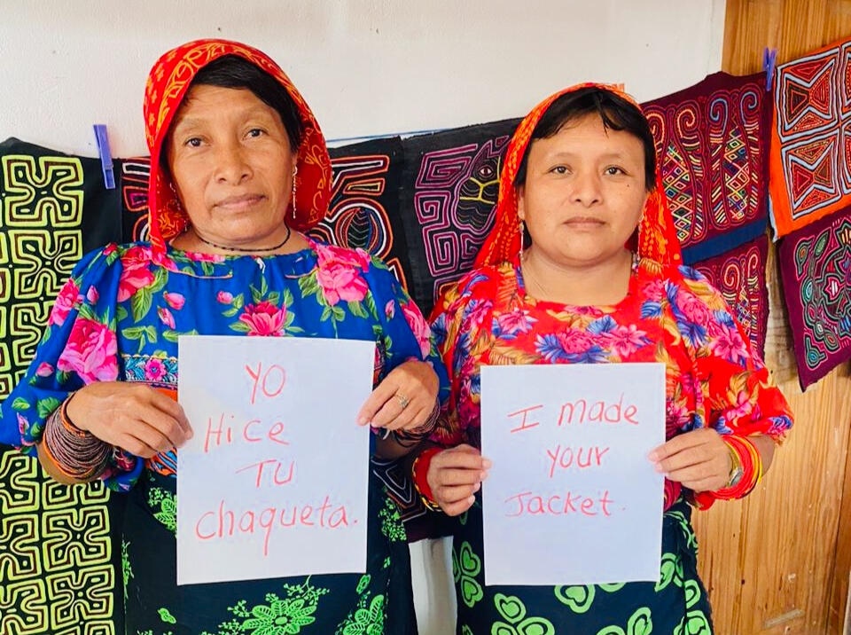 Guna woman dressed in their traditional headress sewing handmade molas from Guna Yala